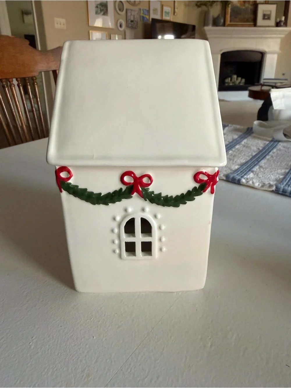 White Ceramic Holiday House with Green Garland and Red Bows
